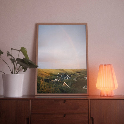 A poster with the photographic motif “Argab” by POWSTR hanging in a living room.