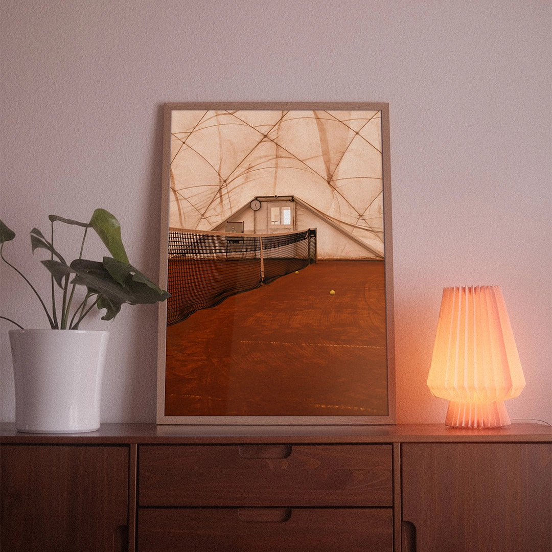 A poster with the photographic motif “Court Net” by POWSTR hanging in a living room.