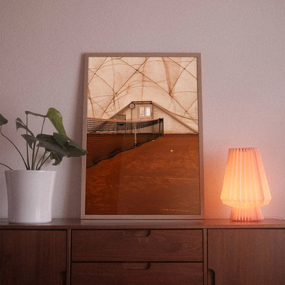 A poster with the photographic motif “Court Net” by POWSTR hanging in a living room.