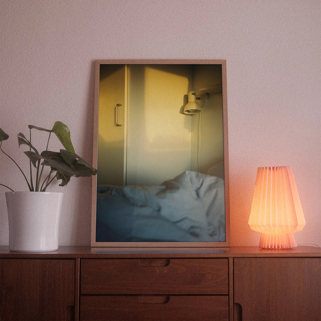 A poster with the photographic motif “Danish Morning” by POWSTR hanging in a living room.
