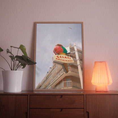 A poster with the photographic motif “Gelati Artigianali” by POWSTR hanging in a living room.