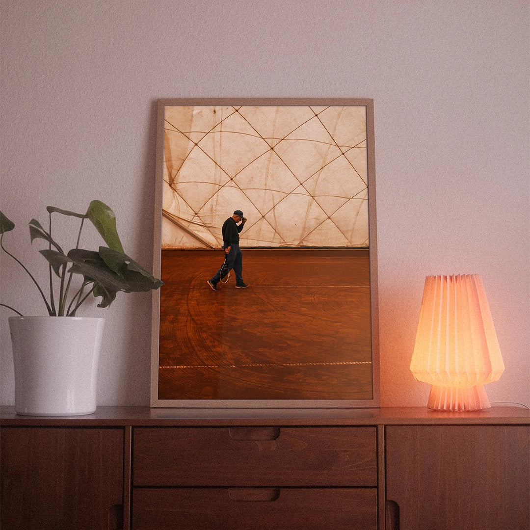 A poster with the photographic motif “Match Point” by POWSTR hanging in a living room.