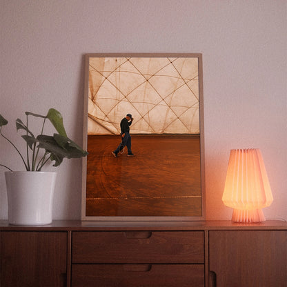 A poster with the photographic motif “Match Point” by POWSTR hanging in a living room.