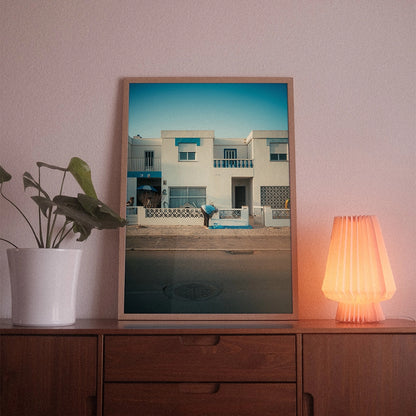 A poster with the photographic motif “Sagres” by POWSTR hanging in a living room.