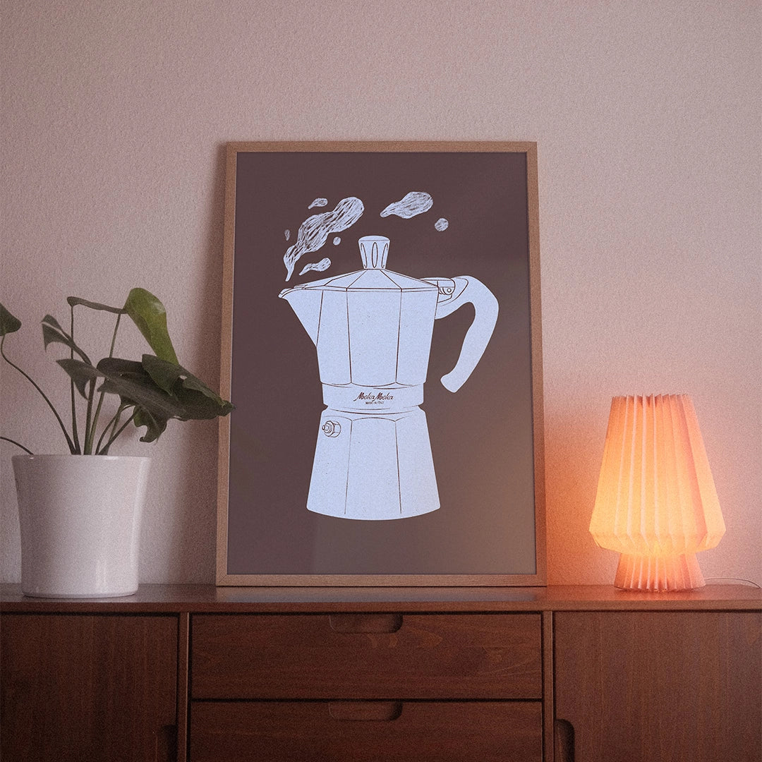 A poster with the illustrative motif “Espresso Maker” by POWSTR hanging in a living room.