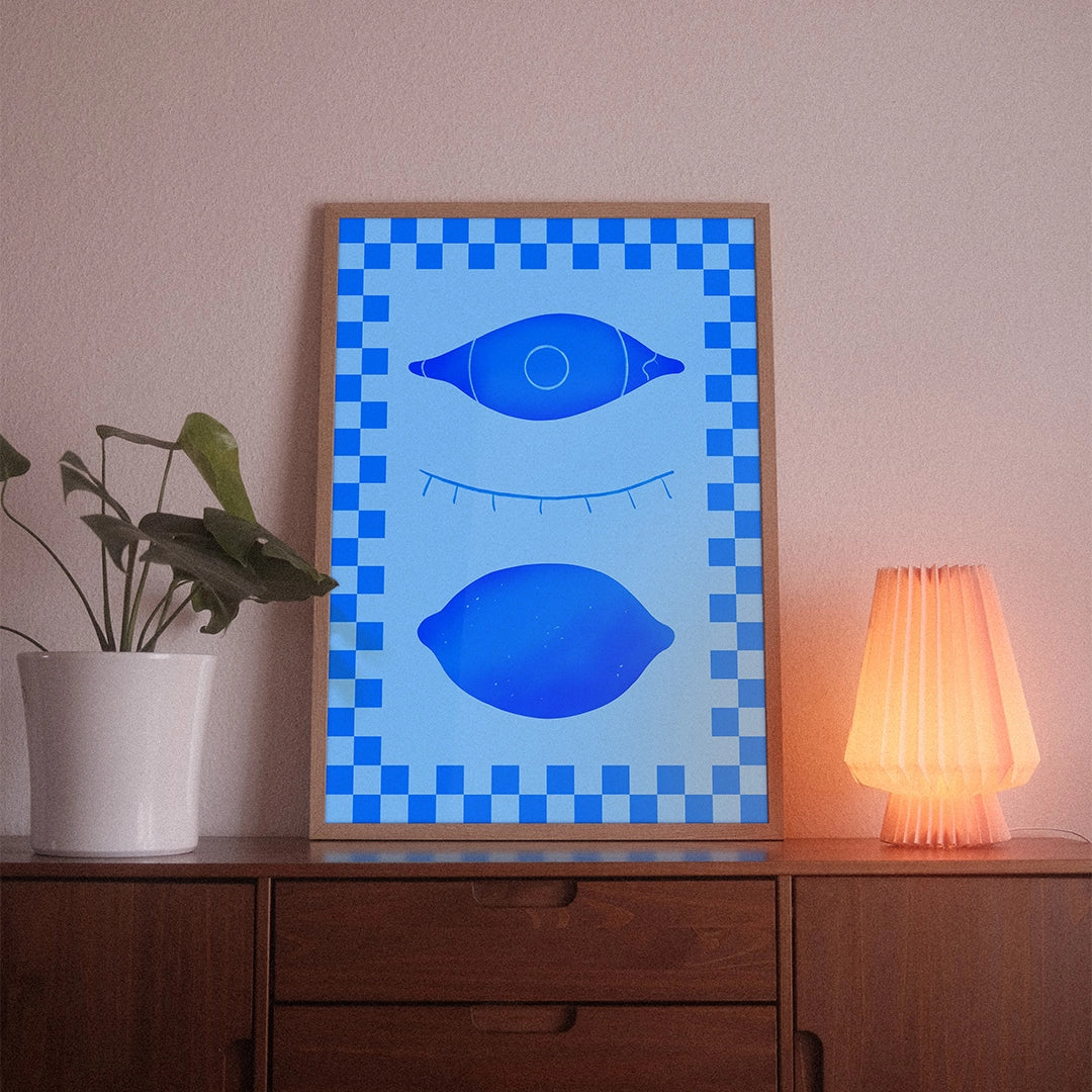 A poster with the illustrative motif “Eyes Closed” by POWSTR hanging in a living room.