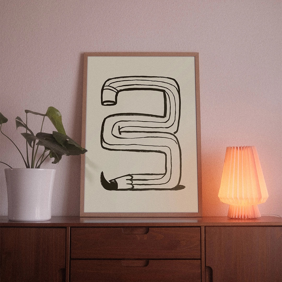 A poster with the illustrative motif “Pen” by POWSTR hanging in a living room.